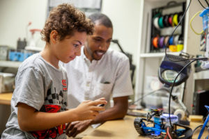 mentor and mentee playing with robotics