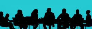 silhouette of people at a board table